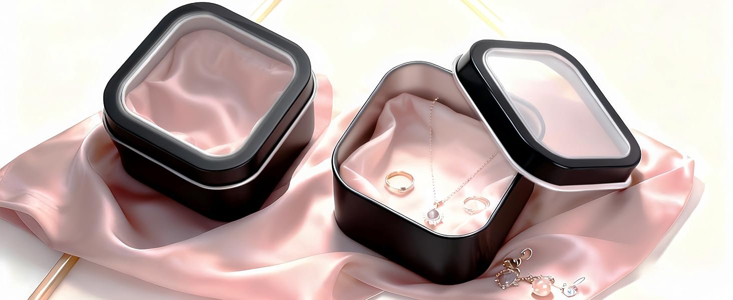 Two LJY window tins resting on pink silk, one open with small keepsakes